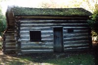 [Photo of Lincoln's log cabin]
